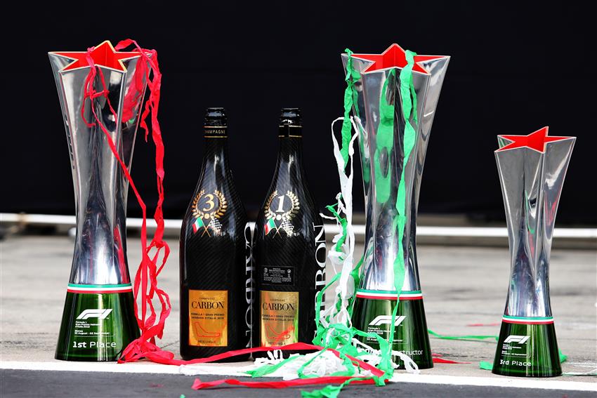Three trophies and two bottle of champagne
