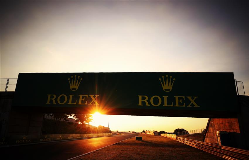 Rolex sign and sunset